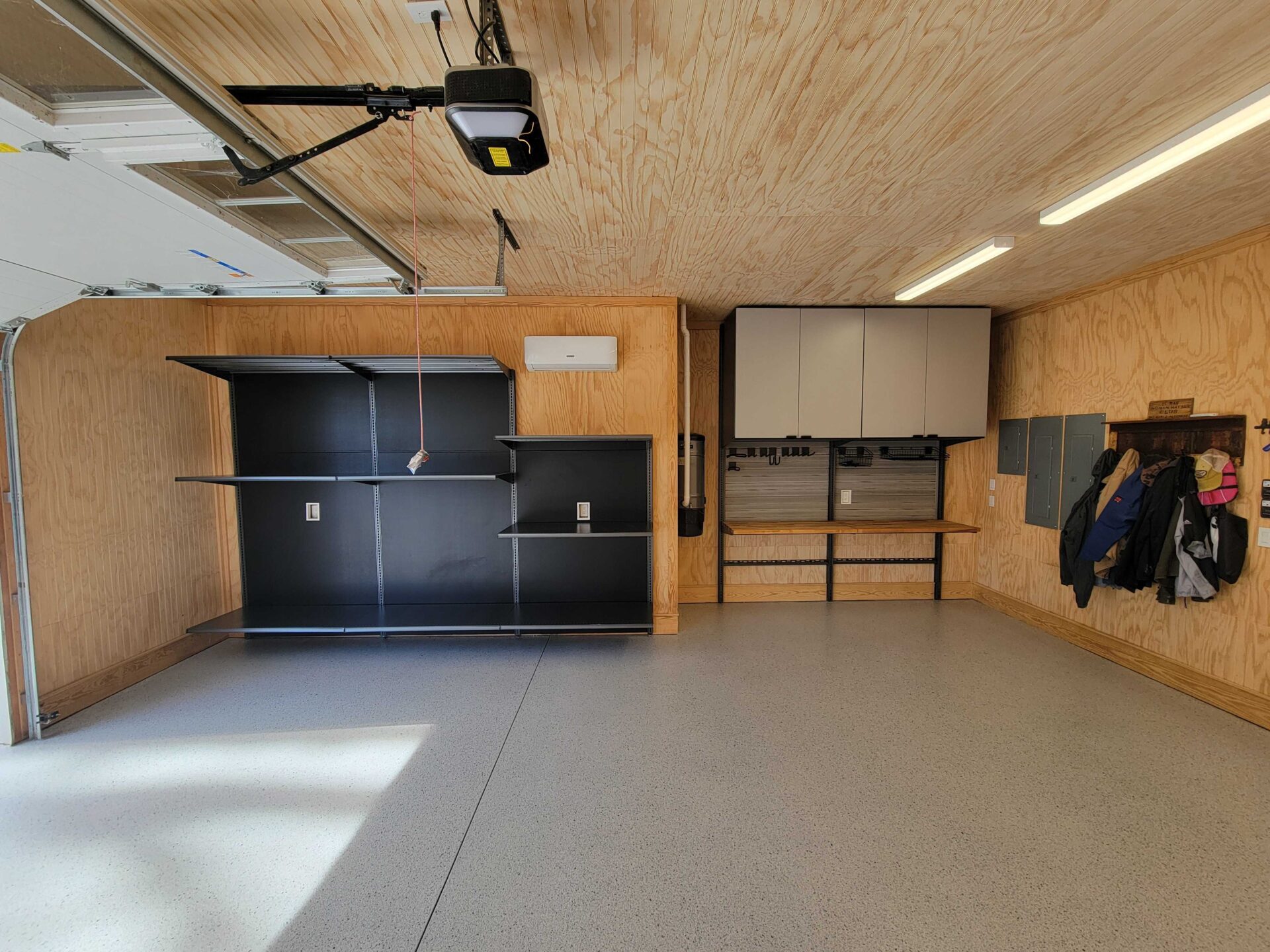 Clean garage with cabinets and shelving