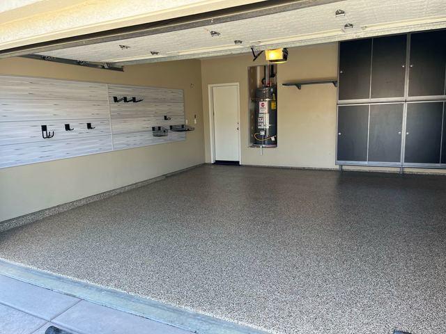 Garage with cabinets and slatwall