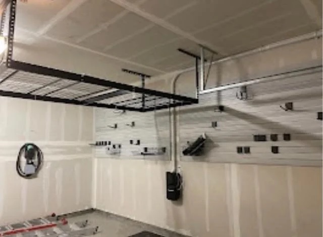 Garage with overhead storage, vacuum and slatwall