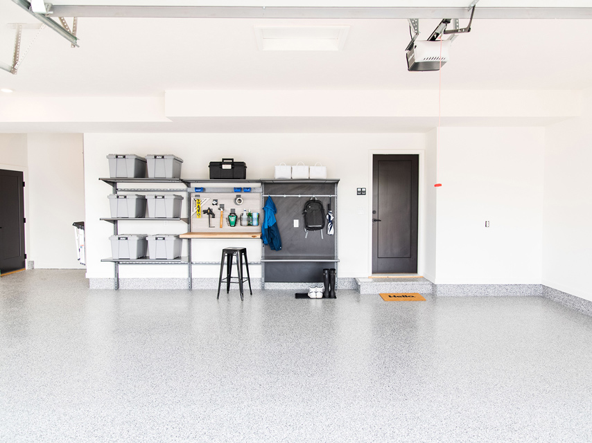 Garage with shelving and gray floor coating