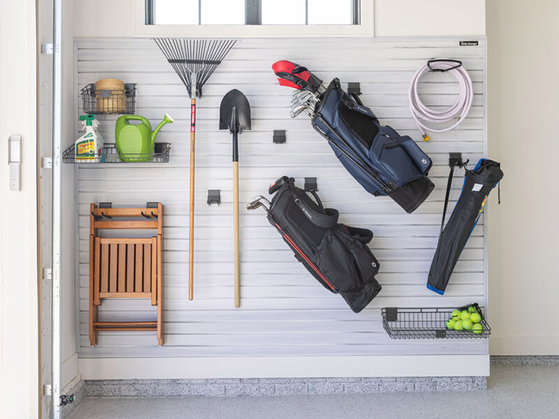 Gray slatwall with various hooks and equipment hanging