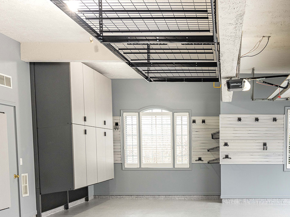 Garage with cabinets and slatwall