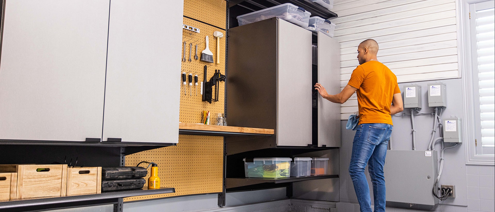 Worker installing garage cabinets