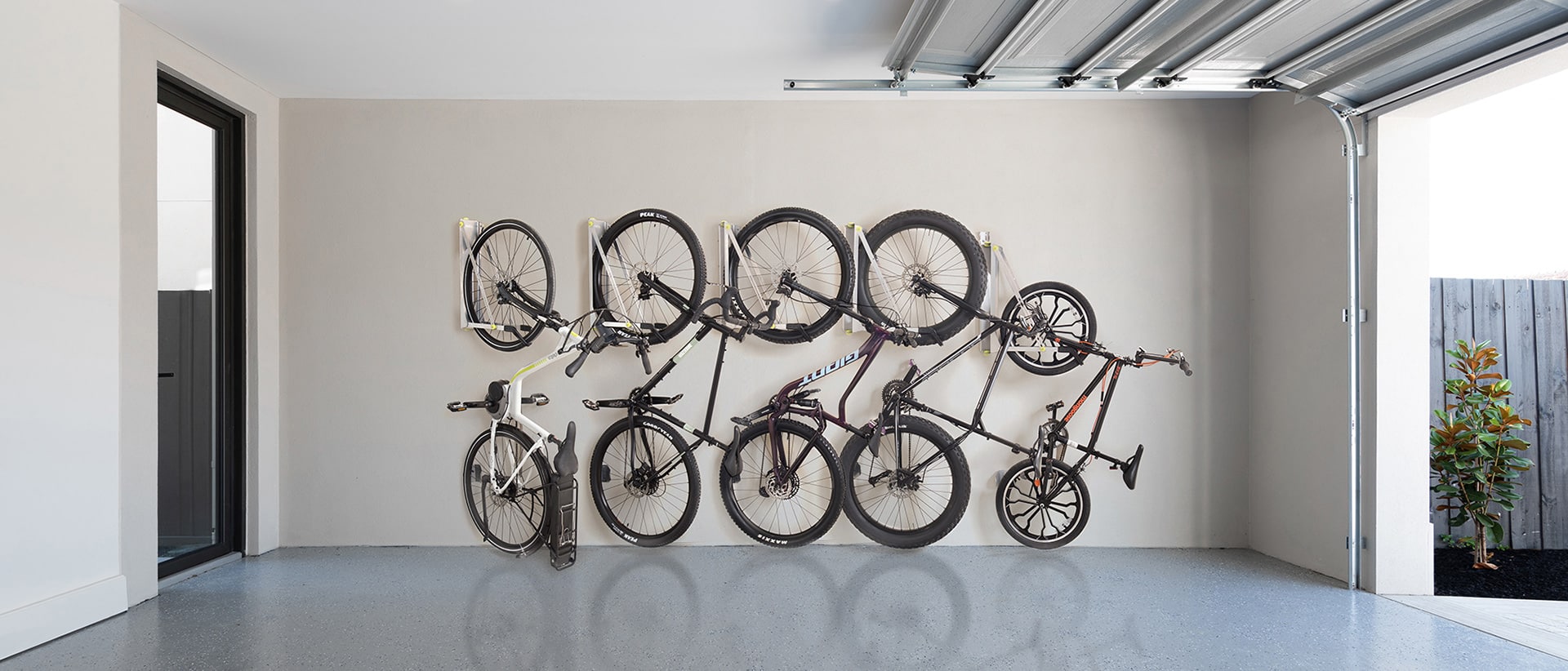 Bikes hanging on wall storage in garage