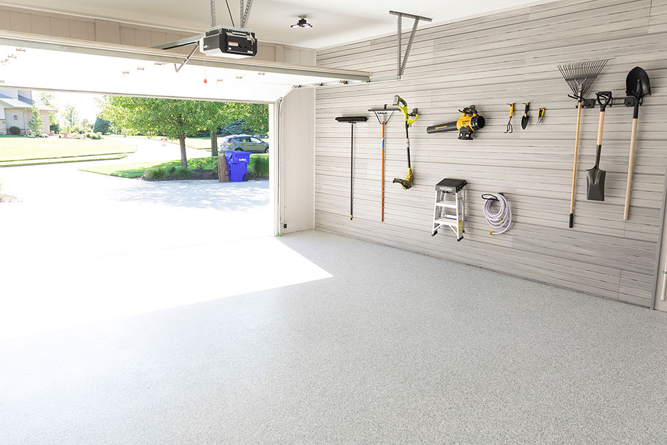 Garage with wall storage and tools hanging from hooks