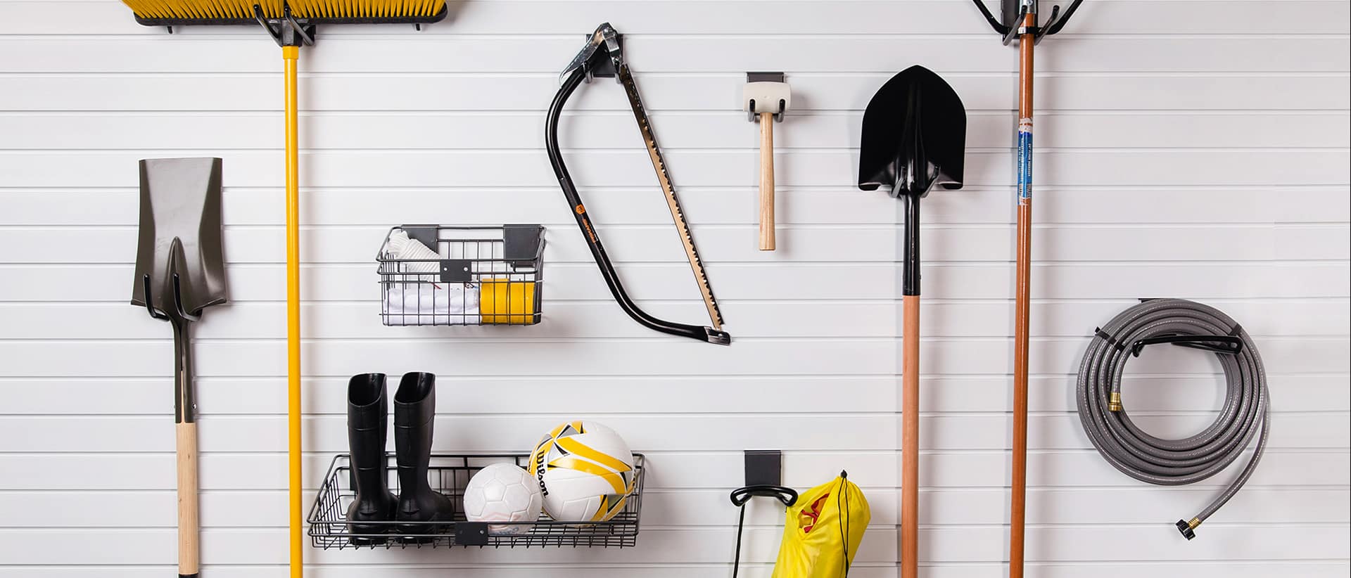 Tools hanging on garage wall using wall storage